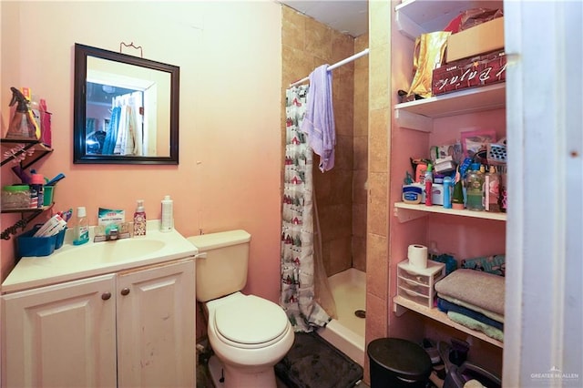 bathroom featuring toilet, vanity, and walk in shower