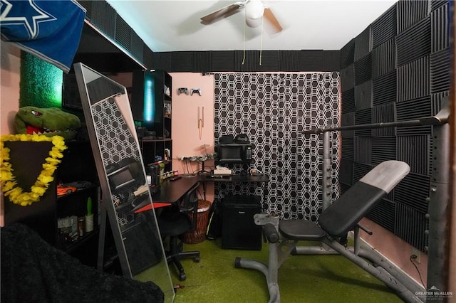 carpeted office space with ceiling fan