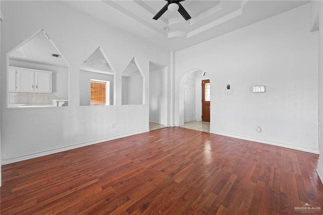 4217 W Ithaca Ave, Mcallen, TX 78501 - spare room with arched walkways, wood finished floors, ceiling fan, and a tray ceiling