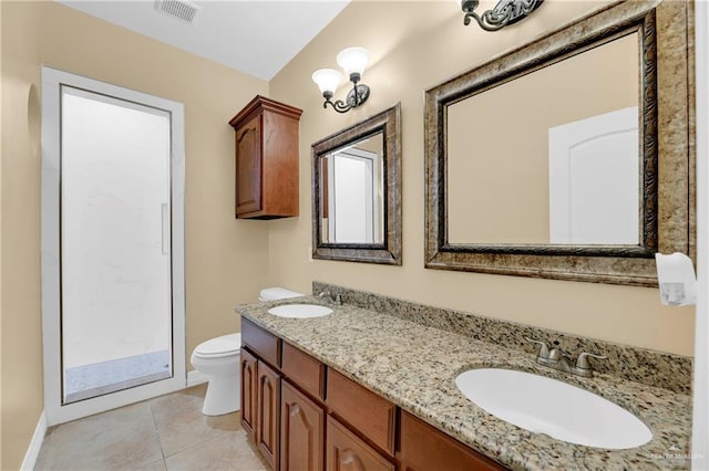 bathroom featuring tile patterned flooring, vanity, and toilet