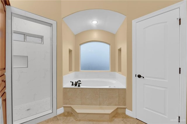 bathroom featuring tile patterned flooring and independent shower and bath