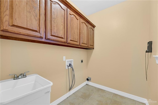 washroom featuring electric dryer hookup, cabinets, sink, and washer hookup