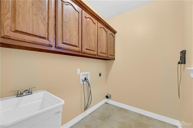 3218 Lerma Dr, Edinburg, TX 78539 - laundry room featuring electric dryer hookup, cabinet space, washer hookup, and light tile patterned floors