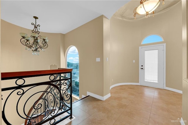 foyer featuring a chandelier and light tile patterned flooring