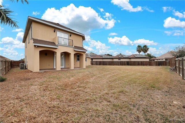 3218 Lerma Dr, Edinburg, TX 78539 - rear view of house with stucco siding, a balcony, and a fenced backyard