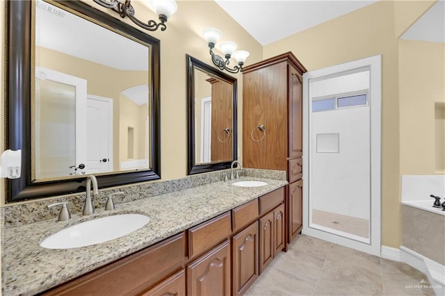 bathroom with tile patterned floors, vanity, and a tub to relax in