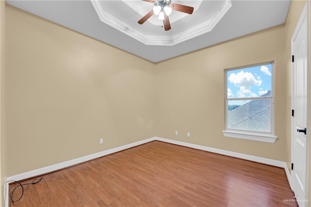 3218 Lerma Dr, Edinburg, TX 78539 - spare room featuring a tray ceiling, ceiling fan, wood finished floors, and ornamental molding
