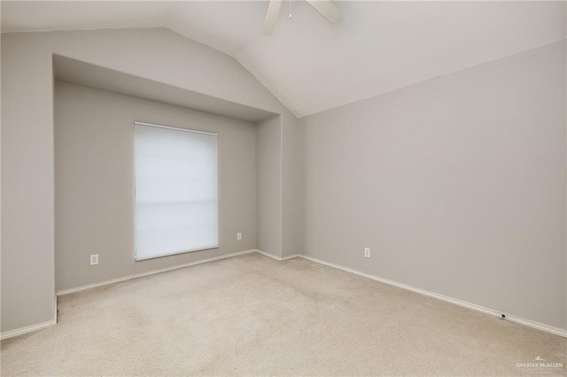 carpeted empty room with ceiling fan and lofted ceiling