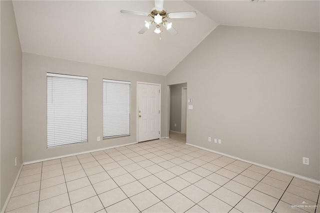 tiled spare room with ceiling fan and vaulted ceiling