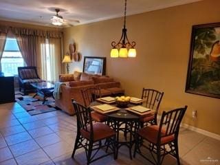 tiled dining room with ceiling fan with notable chandelier