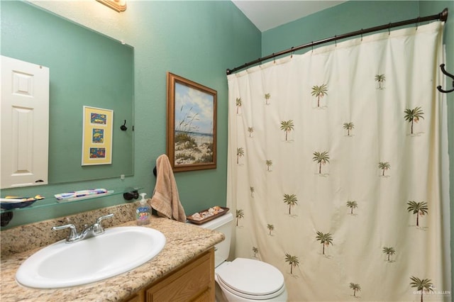 bathroom featuring a shower with curtain, vanity, and toilet