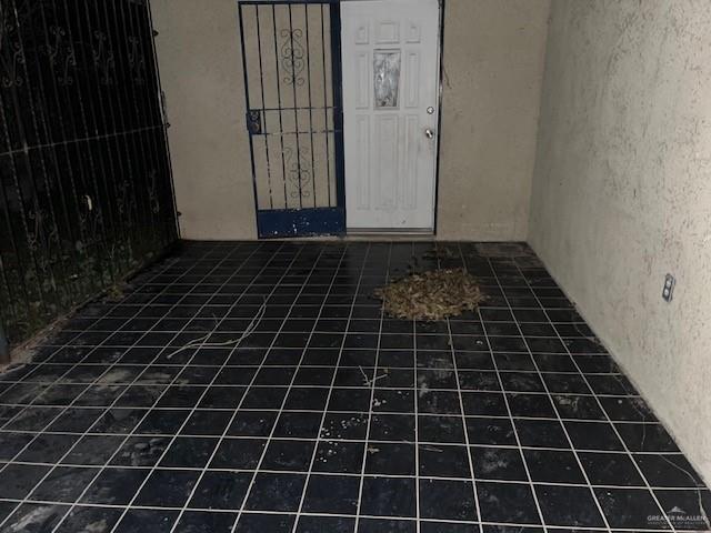 interior space featuring dark tile patterned flooring