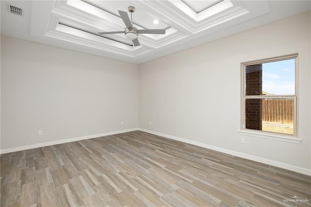 empty room featuring light wood-style flooring, coffered ceiling, baseboards, and a ceiling fan