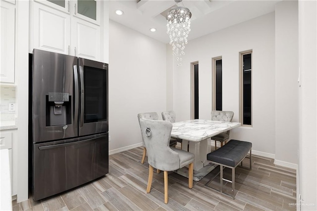 dining area featuring an inviting chandelier, recessed lighting, baseboards, and wood finish floors