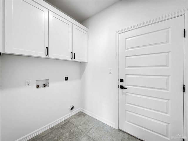 laundry area featuring cabinets, washer hookup, light tile patterned floors, and electric dryer hookup