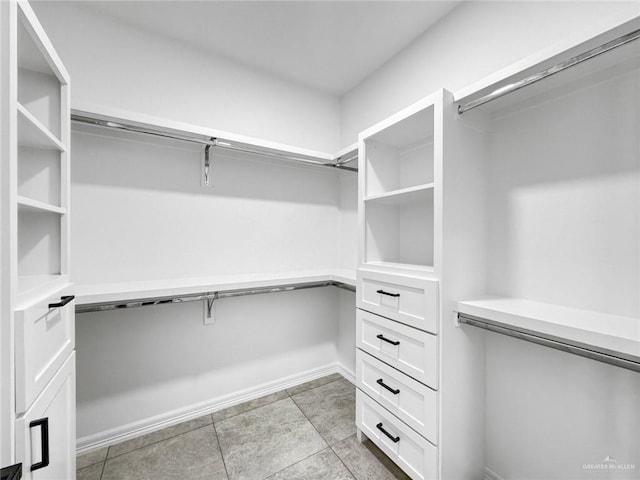 walk in closet featuring light tile patterned flooring