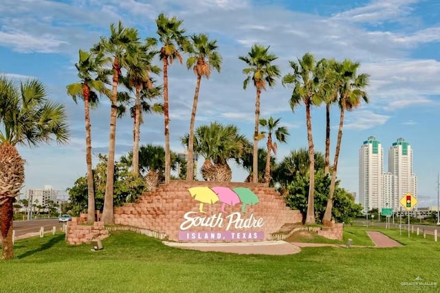 community sign with a view of city and a lawn