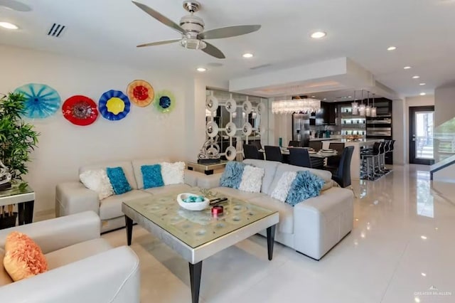 living area with recessed lighting, visible vents, and ceiling fan