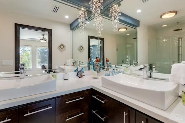 bathroom with double vanity, a sink, visible vents, and a shower stall