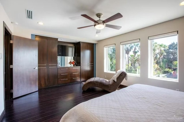 bedroom featuring a ceiling fan, dark wood-style flooring, and visible vents