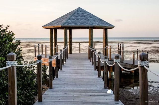 dock area featuring a view of the beach, a water view, and a gazebo