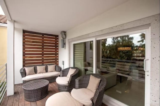 balcony with a sunroom and an outdoor hangout area