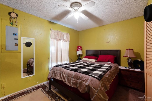 bedroom with baseboards, a textured ceiling, ceiling fan, and electric panel