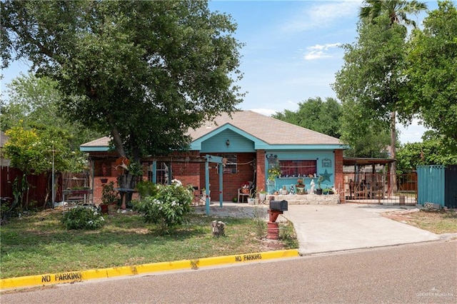 view of community featuring fence, a yard, and concrete driveway