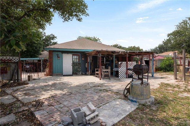 rear view of property with a fenced backyard and a patio area