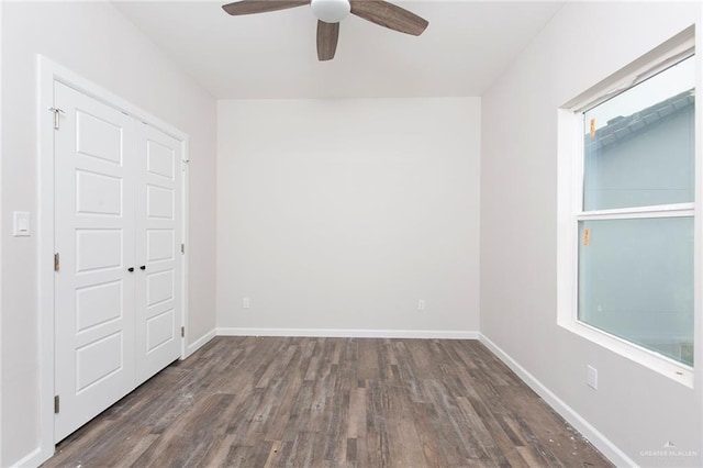 unfurnished room with dark hardwood / wood-style flooring and ceiling fan