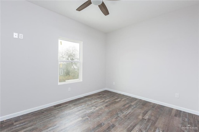 spare room with dark hardwood / wood-style floors and ceiling fan