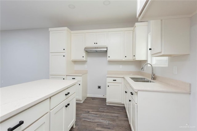 kitchen with dark hardwood / wood-style flooring, sink, and white cabinets