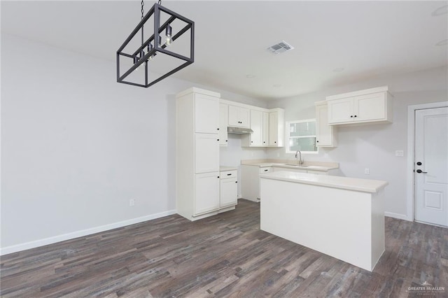 kitchen featuring white cabinetry, a kitchen island, sink, and dark wood-type flooring