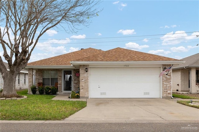 ranch-style house featuring a garage and a front yard