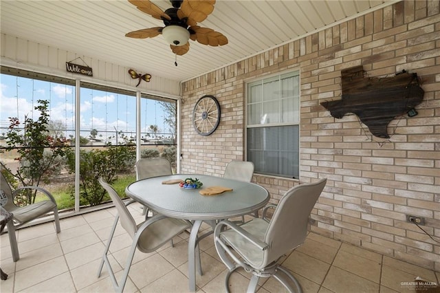 sunroom featuring ceiling fan