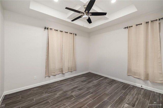 3312 Saturn St, Edinburg, TX 78542 - spare room with a tray ceiling, baseboards, dark wood-type flooring, recessed lighting, and ceiling fan
