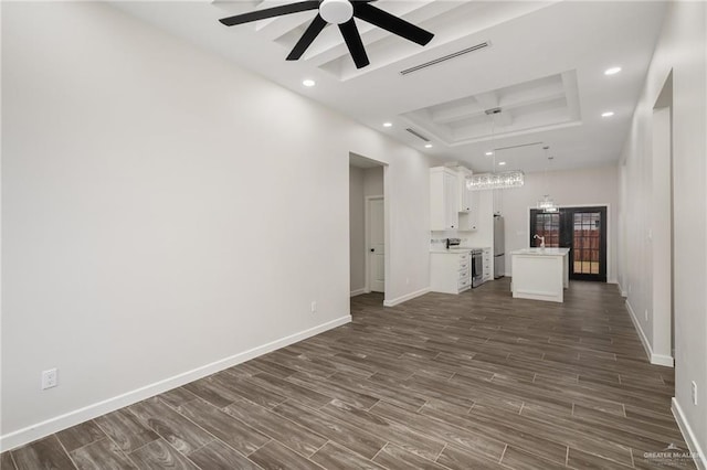 3312 Saturn St, Edinburg, TX 78542 - unfurnished living room featuring a raised ceiling, ceiling fan, baseboards, recessed lighting, and dark wood-type flooring