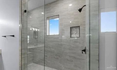 full bathroom featuring a healthy amount of sunlight and a stall shower