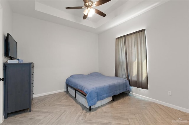 3702 Bea Ave, Harlingen, TX 78552 - bedroom with a tray ceiling, a ceiling fan, and baseboards