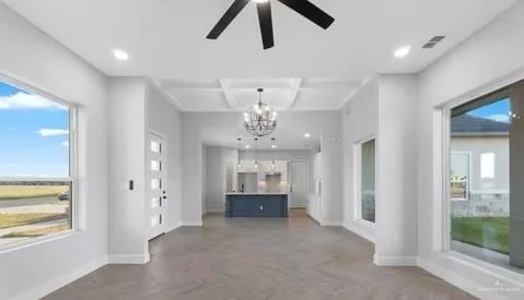 interior space featuring plenty of natural light, visible vents, baseboards, and coffered ceiling