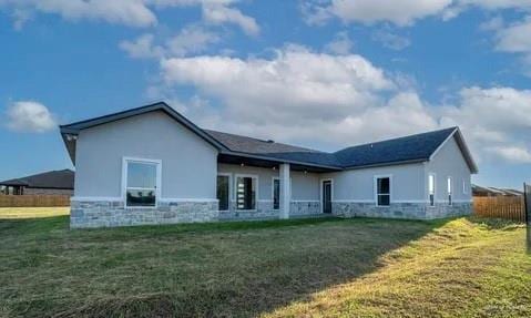 rear view of house with a lawn