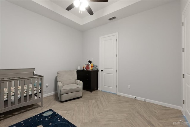 3702 Bea Ave, Harlingen, TX 78552 - bedroom with a tray ceiling, visible vents, a nursery area, baseboards, and ceiling fan