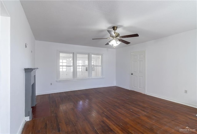 unfurnished living room featuring ceiling fan and dark hardwood / wood-style flooring