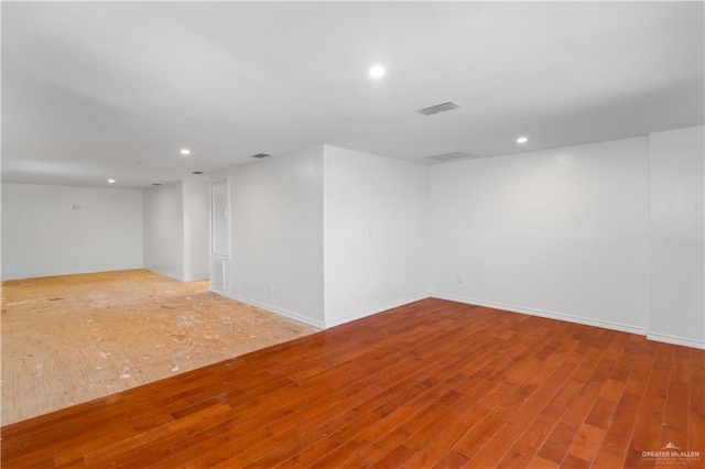 2408 River Oaks Ln, Edinburg, TX 78539 - spare room featuring wood finished floors, recessed lighting, and baseboards