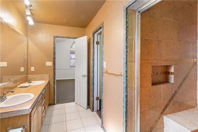 2408 River Oaks Ln, Edinburg, TX 78539 - full bathroom featuring tile patterned floors, double vanity, and a textured ceiling