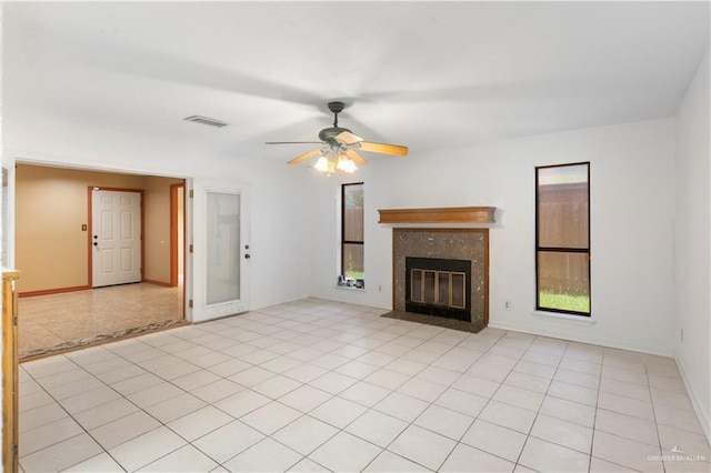 2408 River Oaks Ln, Edinburg, TX 78539 - unfurnished living room featuring plenty of natural light, a ceiling fan, a fireplace, and baseboards