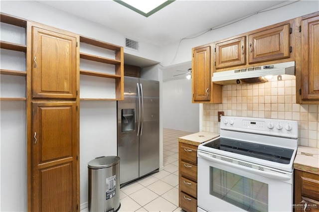 2408 River Oaks Ln, Edinburg, TX 78539 - kitchen featuring white range with electric stovetop, stainless steel fridge, open shelves, under cabinet range hood, and tasteful backsplash