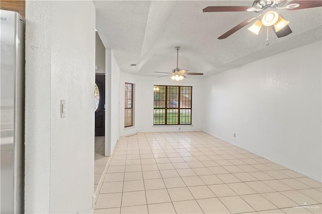 2408 River Oaks Ln, Edinburg, TX 78539 - empty room featuring a ceiling fan, a textured ceiling, light tile patterned floors, and baseboards