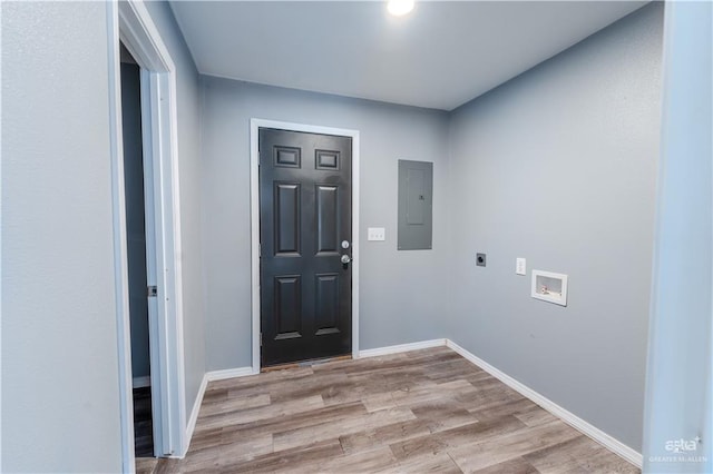 interior space featuring electric panel and light hardwood / wood-style flooring