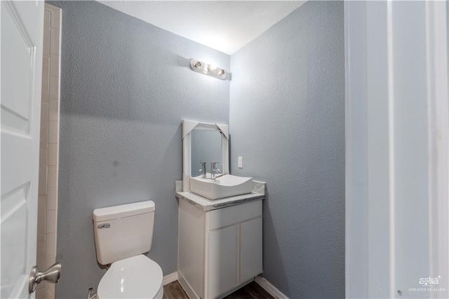 bathroom featuring toilet and vanity